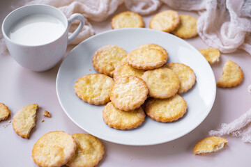 Sweet biscuits for dessert on a white plate. Delicious cookies for breakfast on a plate on a light background. Close-up.