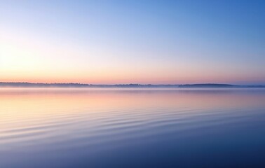 Serene Sunrise Over Calm Waters with Gentle Ripples and Soft Colors of Early Morning Light Reflected in a Tranquil Lake Setting