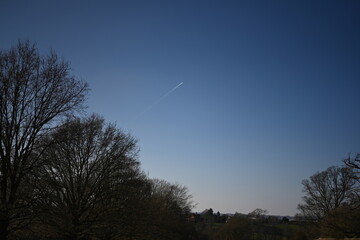 beautiful blue sky with contrail heading to the heavens
