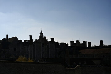 old estate building silhouette against a clear blue sky 