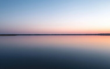 Fototapeta premium Serene Sunset Over Calm Water with Soft Pastel Colors and Gentle Reflections Creating Tranquil Scenery for Nature Lovers and Peaceful Moments