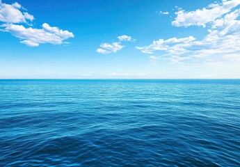 Fototapeta premium Tranquil Blue Ocean Under a Clear Sky with Soft Clouds, Perfect for Relaxation and Nature Inspired Designs in Various Projects