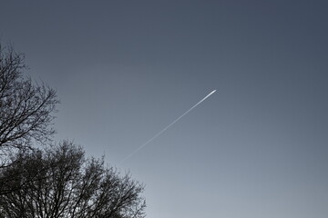 chem trail or contrail against a beautiful clear sky