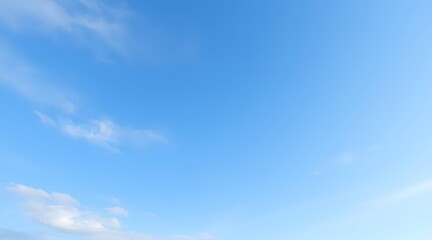 Bright blue sky with soft clouds, creating a serene and tranquil atmosphere perfect for backgrounds or nature-themed projects.  