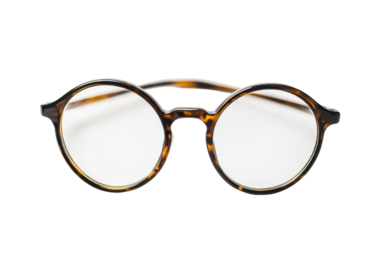 Classic round tortoiseshell glasses resting on a minimalist white background showcasing simplicity isolated on transparent background