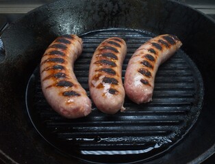 Cooking method: sauté pork sausages in a cast iron skillet.