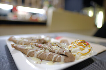 Delicious crepes drizzled with sweet toppings and served with a dollop of whipped cream a delightful culinary creation