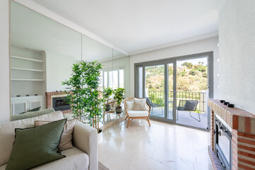 an image of a living room with mirror walls and stone fireplace in mediterranean apartment 
