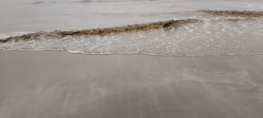 Close up of small waves breaking near the shore