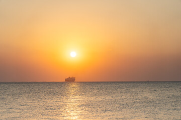 Golden hour on Paradiso Beach by Kos Old Town with Greek Island Ferry in distance