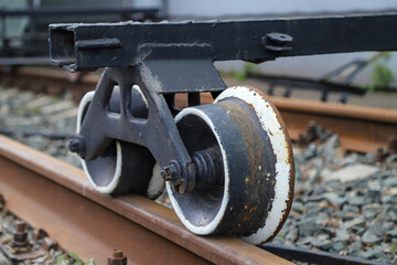 Close-up of an old rusty handcar wheels on rails