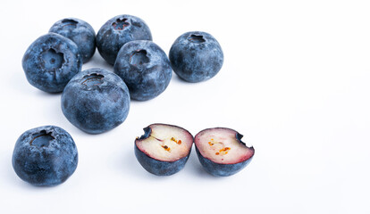 Fresh blueberry cut in half on white background. Close-up.
