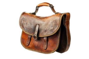 Vintage leather satchel featuring intricate designs, resting on a clean surface with soft lighting isolated on transparent background