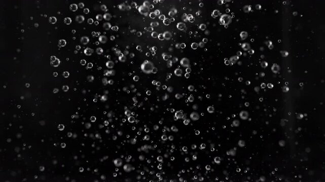 Super Slow Motion Shot of Air Bubbles Rising up, Isolated on Black Background at 1000fps.