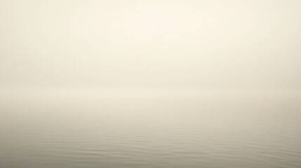 A serene, misty landscape with calm water and soft hues.