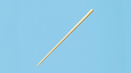 Fototapeta premium A simple wooden chopstick against a light blue background.