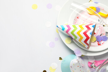 Obraz premium Composition with dirty plates and party decor on grey background