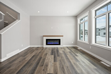 Large room with a fireplace and a window