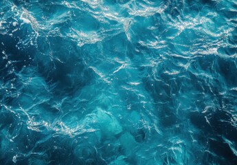 Obraz premium Calm turquoise ocean water rippling gently under the sunlight, showcasing the beauty of nature with vibrant blue hues and reflections in the surface