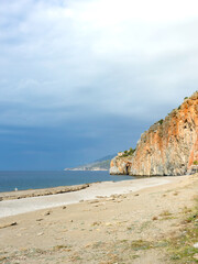 Beach with a rocky cliff in the background