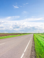 Road with a few cars on it and a few trees in the background