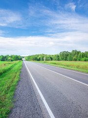 Long road with a clear blue sky above it
