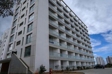 Modern architecture in a bustling urban area showcases sleek lines and expansive balconies, inviting nature indoors