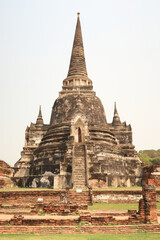 Fototapeta premium Picturesque view onto one of the stupas, pagodas of the Wat Phra Si Sanphet Temple, Ayutthaya Historical Park, Thailand
