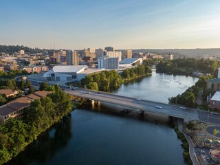 Fototapeta na wymiar An aerial view of Spokane River, Spokane, Washington, shows the city skyline, the Spokane River, and a bridge with cars crossing. The photo captures the urban landscape and riverfront. USA