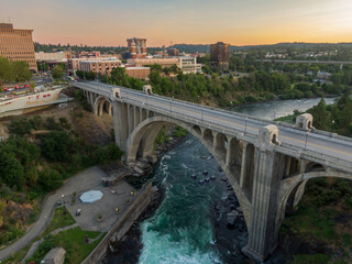 An aerial view of Spokane, Washington, featuring the Monroe Street Bridge. The Spokane River flows...