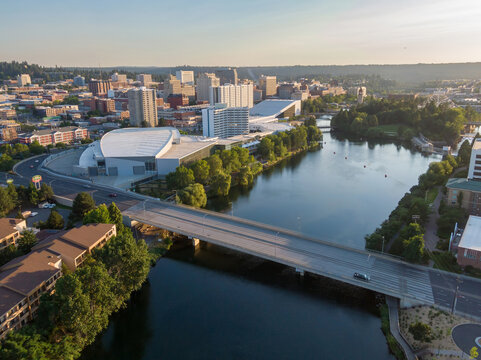 Aerial view of Spokane, Washington, showcasing the Spokane River flowing through the city. The Spokane Convention Center is visible, highlighting the city's infrastructure.  USA