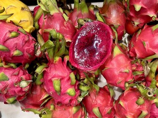 A fancy cut dragon fruit from the Hylocereus cactus, or Honolulu Queen, is piled in display at a...