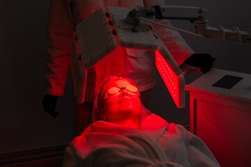 Red light therapy session for skin rejuvenation in a spa environment