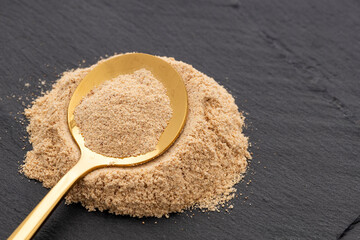 Ground organic maca in the spoon - Lepidium meyenii