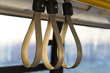 Passenger hand straps in public transport