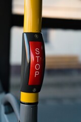 Public transport stop request button on handrail
