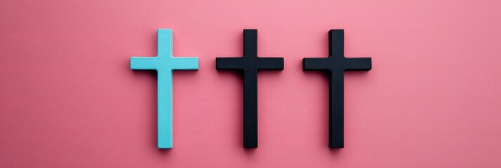 Obraz premium Easter Holiday, Easter Concept, Three Wooden Crosses Teal and Black on Pink Background Religious Symbol Faith Concept