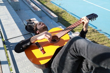 Young Musician Player Having Fun Making Chords With Classical Guitar