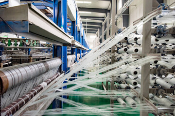 The weaving workshop machinery of a certain packaging factory is running, producing new fiber ropes...