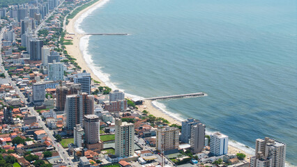 Close-up aerial view of the beach in Balneário Piçarras, located in Santa Catarina, Brazil, highlighting the sand and ocean.