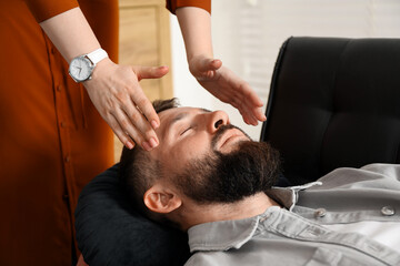 Psychologist working with patient during hypnosis session indoors, closeup