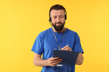 Technical support call center. Operator working with clipboard on yellow background