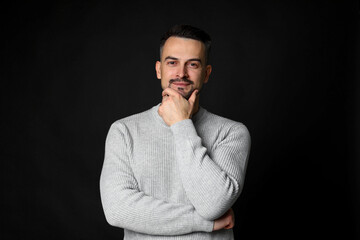 Fototapeta premium Portrait of handsome middle aged man on black background
