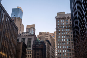 A breathtaking view of Brooklyn showcasing its diverse architecture, from historic brownstones to contemporary buildings, with the iconic Manhattan skyline rising in the background. The contrast betwe