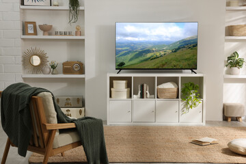 TV set with mountain landscape on screen in room