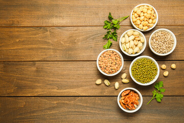 Superfood. Different healthy food products on wooden table, flat lay. Space for text