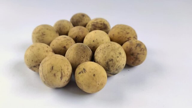 A group of Duku fruits or lanzones or Lansium domesticum on a white background