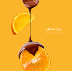 Creative layout made of bar of dark  chocolate and orange fruit on the yellow background. Flat lay. Food concept.  Melted chocolate on the orange fruit on the yellow.