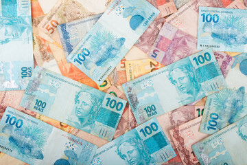 Various Brazilian real banknotes, including 100, 50,20, 10, 5, and 2 reais. Finance, economy, and currency exchange