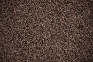 loosened soil as a background. brown ground surface